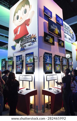 Attendees test new video games at E3 (Electronic Entertainment Expo), in Los Angeles, California, June 2014.
