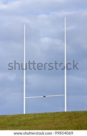 Tall rugby union goal posts and cloudy blue skies