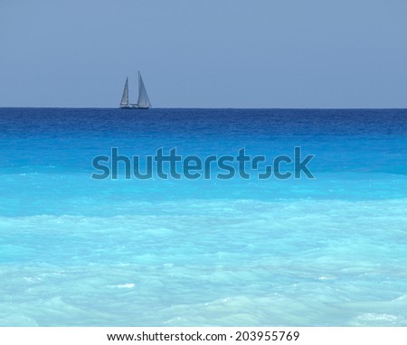 sailboat with a white sail, blue Mediterranean sea ocean horizon