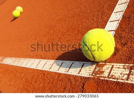 Tennis balls on a tennis clay court