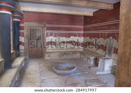 HERAKLION, CRETE ISLAND, GREECE - JULY 10, 2013: Throne Room with the stone throne and griffon frescoes on the walls in  Knossos Palace.
