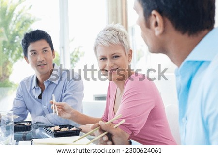 Similar – Image, Stock Photo Ethnic businesswoman eating sushi and working on laptop in cafe