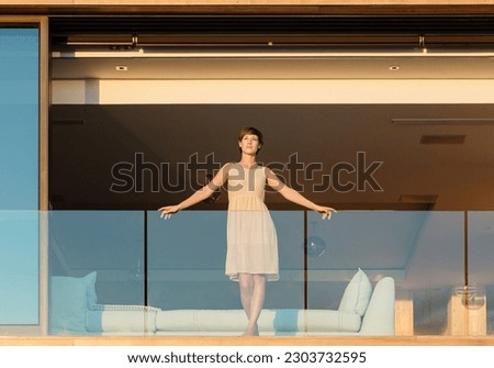 Similar – Image, Stock Photo Woman standing on balcony looking over the ocean