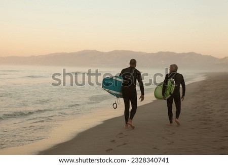 Similar – Image, Stock Photo Man in wetsuit on paddleboard in sea