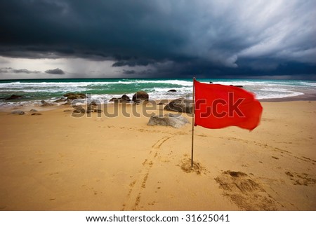 Red warning flag at Surin beach. Phuket, Thailand.