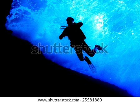 scuba diver silhouette in tropical waters; maui, hawaii