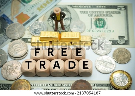free trade is the opposite of trade protectionism or economic isolationism.free agreement.laissez-faire trade or trade liberalization.The word is written on  money and gold background Stock photo © 