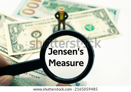 Jensen's Measure.Magnifying glass showing the words.Background of banknotes and coins.basic concepts of finance.Business theme.Financial terms. Stock fotó © 