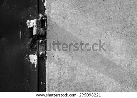 Abstract in black and white : Old and Rusted decay hinge with iron door and cement wall
