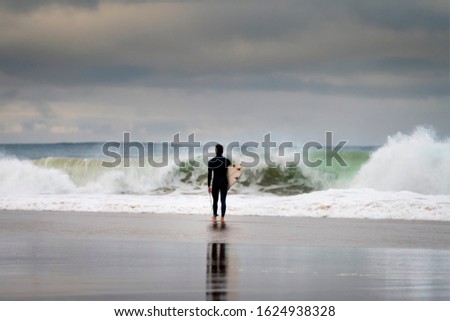 Similar – Image, Stock Photo Surfer entering into the water with his surfboard.