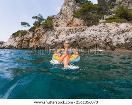 Similar – Image, Stock Photo rubber slippers float in clear water next to female legs