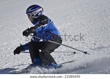 Young boy downhill skiing