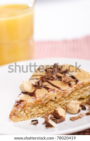 Piece of cake with chocolate and juice on white plate