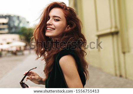 Similar – Image, Stock Photo Gorgeous dark-haired young woman stands with big eyes and demanding look in an old willow tree with fine shoulders