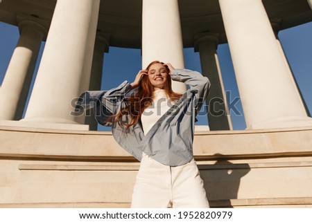 Similar – Image, Stock Photo Gorgeous woman touching columns in park