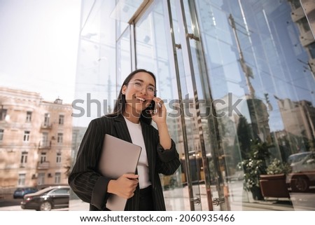 Image, Stock Photo Long-haired brunette Asian woman dressed in a white sweater, looking in the mirror and combing her hair