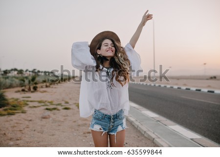 Similar – Image, Stock Photo Woman smiling, standing outside cafe looking at Christmas lights. Magic winter holiday season ambience.