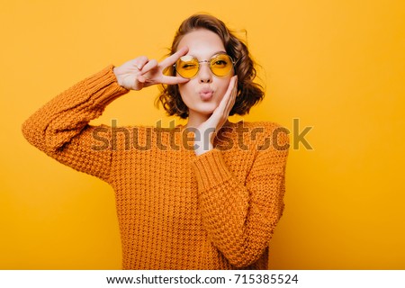 Similar – Image, Stock Photo Fun portrait of girl with her trendy white sweater over her head hiding, cold. Listening to music with headphones. Woman with tied hair. Photo in studio.