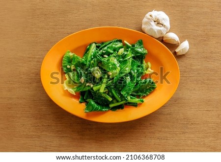 Fried Kai Lan Oyster Sauce  with fried garlic (Chinese Broccoli) on wooden background top view food Imagine de stoc © 