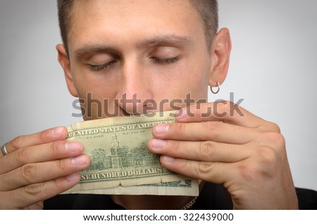 portrait of greedy man holding dollars