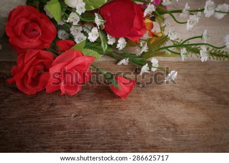 Bouquet of red roses on wood