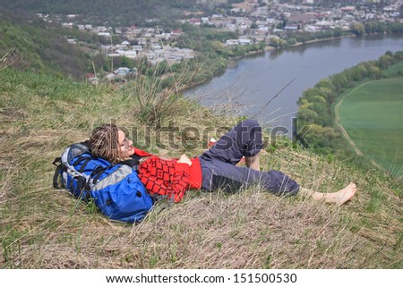 Young Happy Girl with African Braids and with Backpack Sleep near Big River