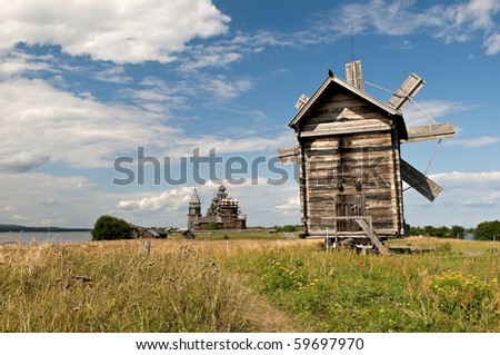 Windmill and old wooden chapel in Russian north, Kizhi island, Lake Onega