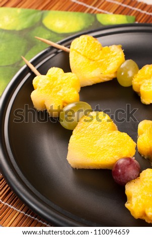 Grapes and diced pineapple on a skewer, a healthy desert