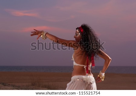 Oriental dance on an evening beach setting