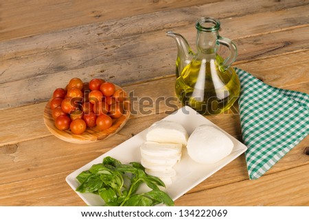 Still life including mozzarella and salad ingredients