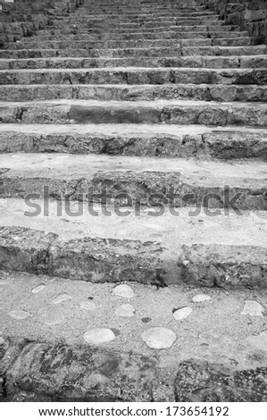 Full frame black and white take of old steps climbing a street