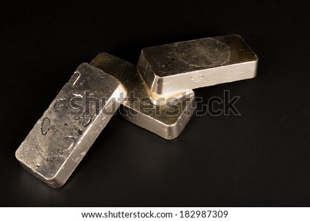 Low key take of sterling silver bars on a black background