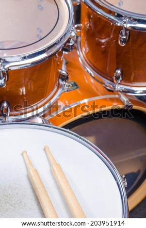 Two drumsticks on top of a drum kit