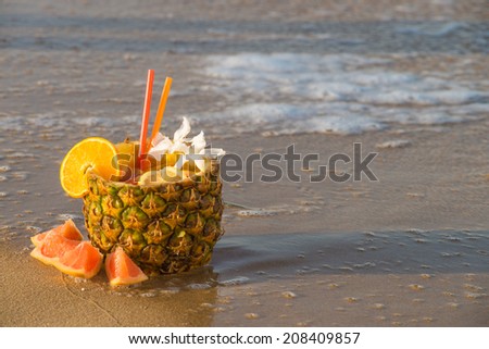 Refreshing pineapple cocktail served inside a whole fruit