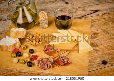 Spanish snacks displayed on a wooden board