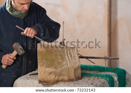 Sculptor just starting to carve art out of stone