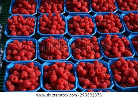 Raspberry sold on the market in small blue boxes