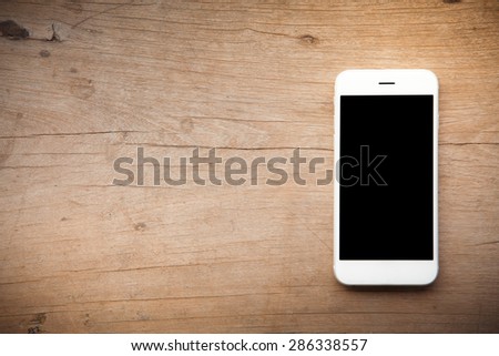 Smart phone on wooden background