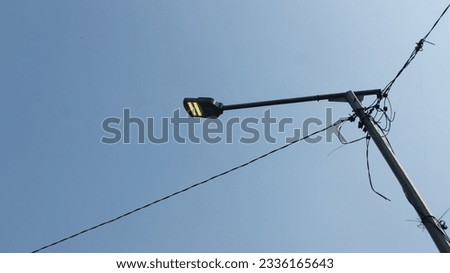 Similar – Image, Stock Photo Wild connected light bulb with cable net in a socket in front of a palm tree