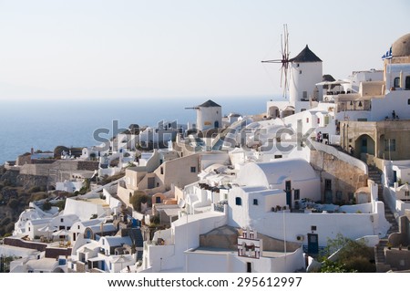 Windmills of the town of Oia, Santorini, Cyclades, Aegean Sea, Greece, the horizon of the sea bottom.