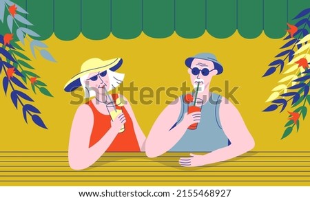 Elderly couple drinking cocktails in street cafe or beach bar. Relationships and friendships of older people. Senior man and woman spending time together and enjoy summer vacation in tropical country