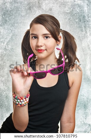 Portrait of cute teen girl with pony tails looking at camera over textured  background