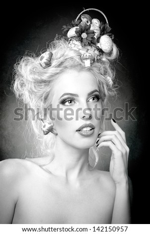 attractive blonde girl with fashion hair-style with mushrooms.Luxuriant . Femininity. Fashion Model with mushrooms in her hair.Glamorous female. Luxury coiffure and make up
