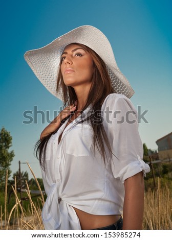 Portrait of attractive beautiful young woman in summer cap closeup, against blue sky.Woman with sun hat