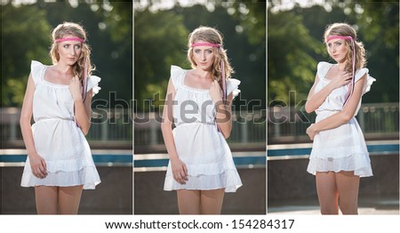 Attractive girl in white short dress sitting on parapet near the fountain in the summer hottest day.Girl with dress partly wet playing with water.Portrait of beautiful blonde women near the fountain