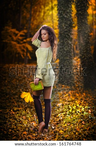 Young caucasian sensual woman in a romantic autumn scenery .Fall lady .Fashion portrait of a beautiful young woman in autumn forest. Beauty autumn
