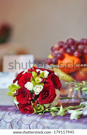 beautiful bouquet of rose flowers, on table .wedding bouquet  from red roses.elegant wedding bouquet on table at restaurant