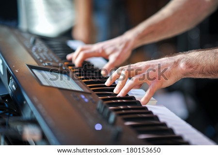 closeup shot of male hands playing the piano .Human hands playing the piano on the party . Man playing the synthesizer keyboard