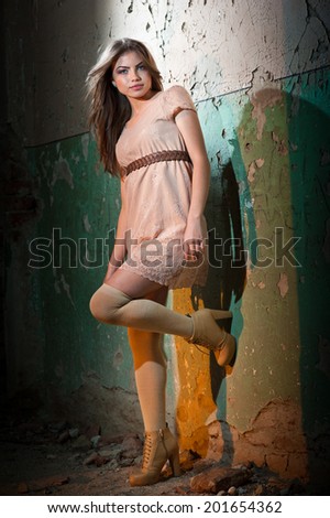 full lenght portrait of sensual girl in old house.Fashion scene of young lady. Beautiful lady with stocking near a wall