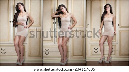 Charming young brunette woman in tight fit short nude dress leaning against wooden wall. Sexy gorgeous long hair girl near vintage wardrobe. Full length portrait of sensual female posing provocatively